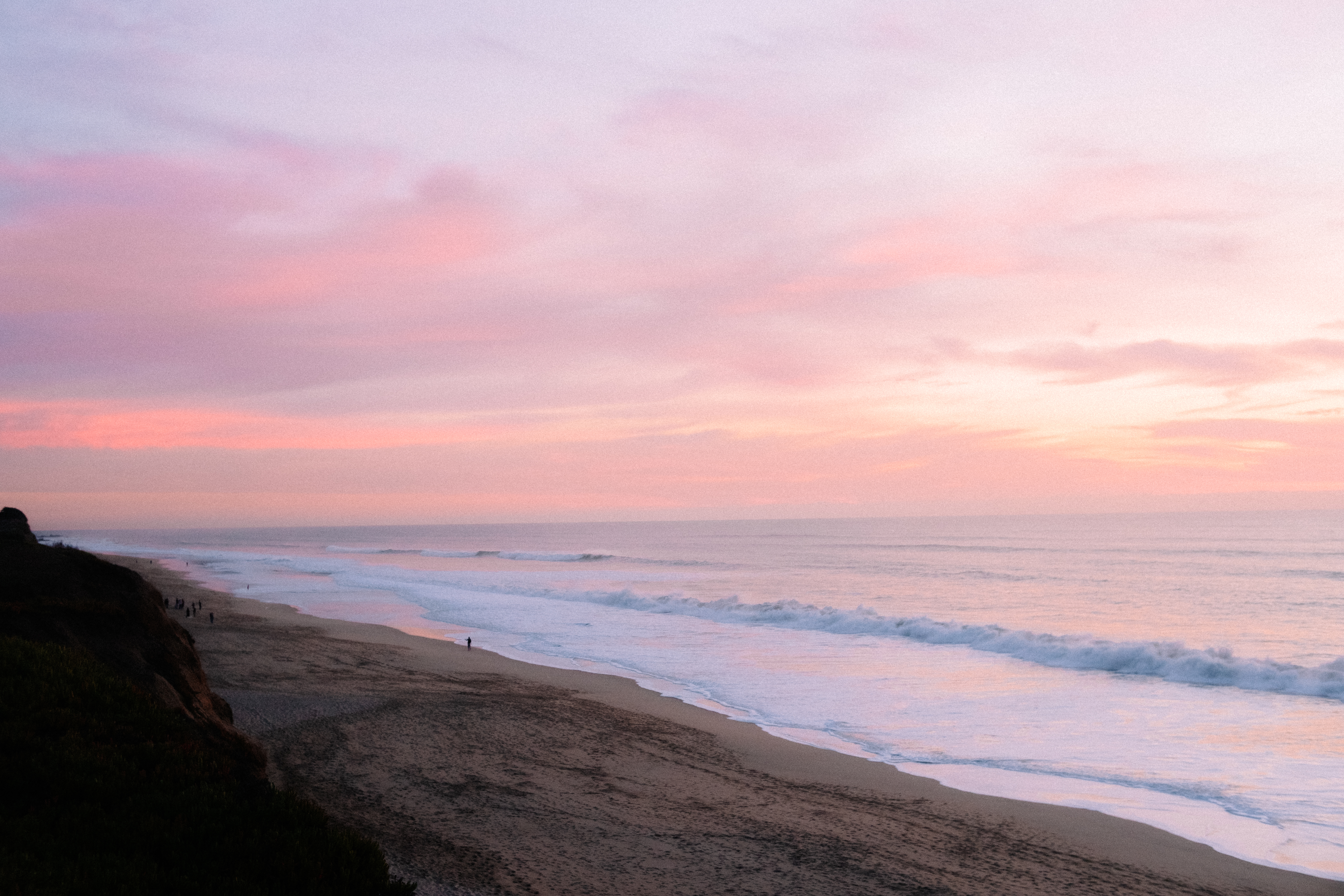 Pink sunset over the ocean shoreline